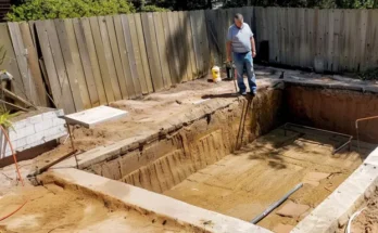 A man standing in a dug-up backyard | Source: Amomama