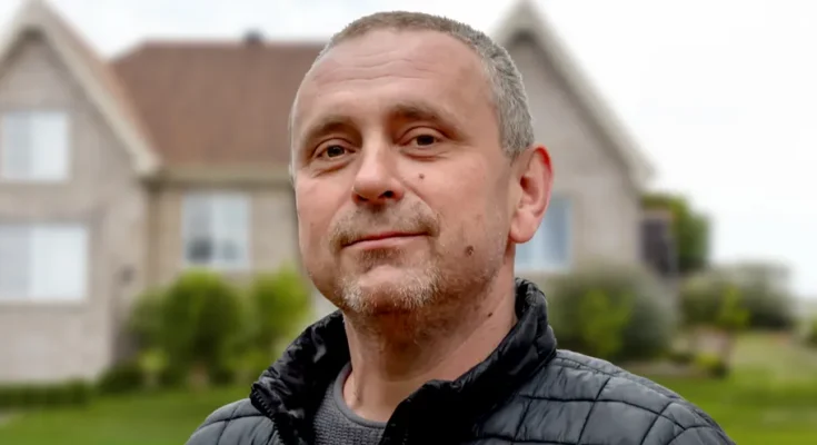 A mature man standing outside a house | Source: Shutterstock