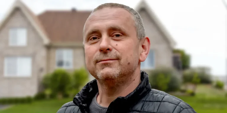 A mature man standing outside a house | Source: Shutterstock