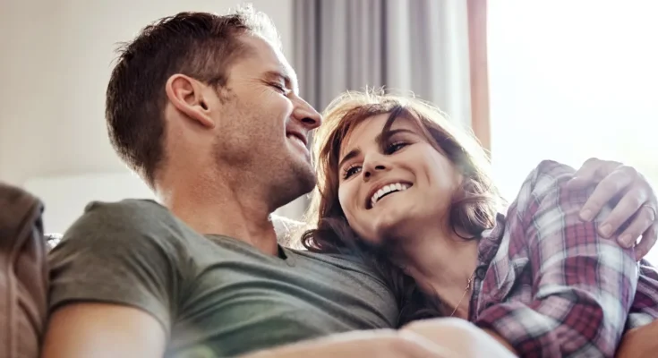 A husband and wife laughing | Source: Shutterstock