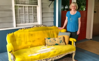 A woman standing next to an old, stained couch | Source: AmoMama