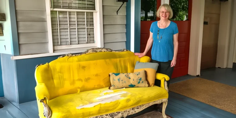 A woman standing next to an old, stained couch | Source: AmoMama