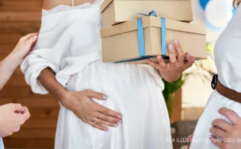 A pregnant woman holding her belly | Source: Shutterstock