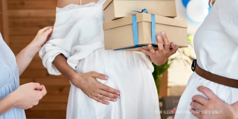 A pregnant woman holding her belly | Source: Shutterstock