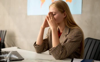 A frustrated woman sits at a desk | Source: Freepik