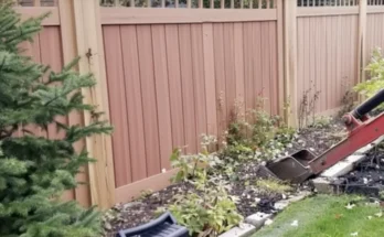 A machine working on a garden close to a wooden fence | Source: Amomama