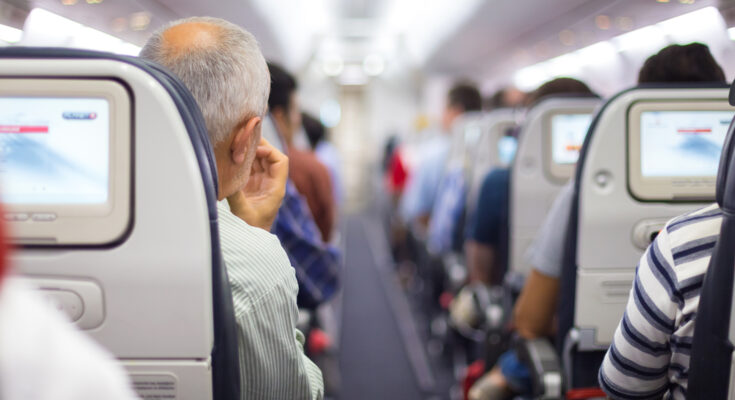 Passengers seated on a plane | Source: Shutterstock