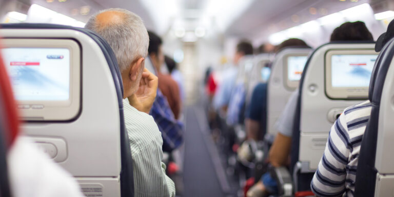 Passengers seated on a plane | Source: Shutterstock