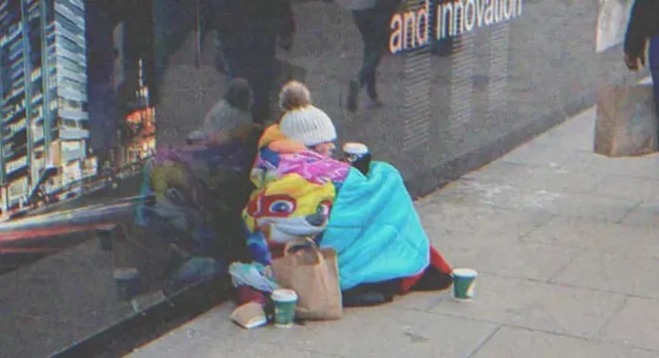 Homeless woman sitting on the street | Source: Shutterstock