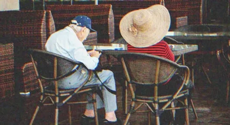 A couple of elders sitting in a restaurant | Source: Shutterstock