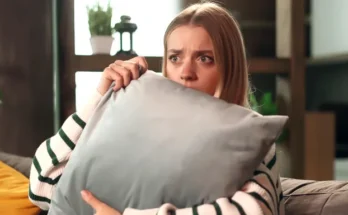 A woman holding a pillow | Source: Shutterstock