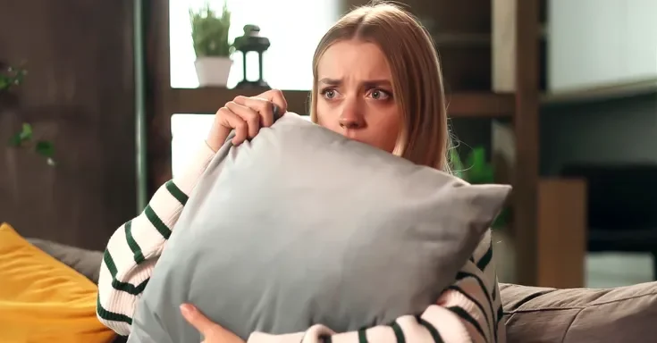 A woman holding a pillow | Source: Shutterstock