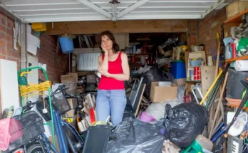 A woman standing in a garage filled with various items | Source: Shutterstock