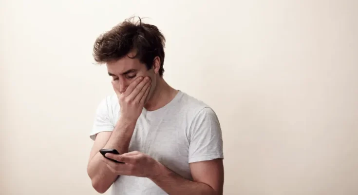 A man looks at his phone | Source: Getty Images