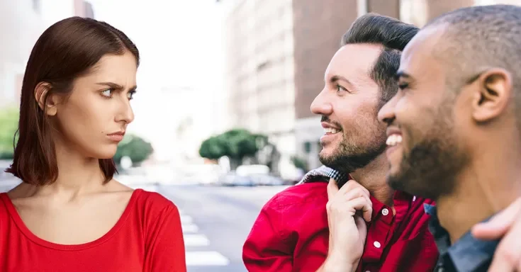 A woman frowning at two men | Source: Shutterstock