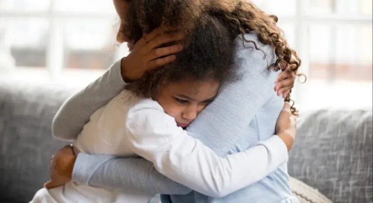 Woman hugging a child | Source: Shutterstock