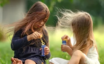 Two girls playing outside | Source: Shutterstock