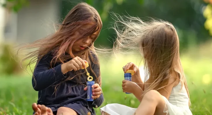 Two girls playing outside | Source: Shutterstock