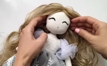 A person's hands and a doll | Source: YouTube/CraftyGirlShirin