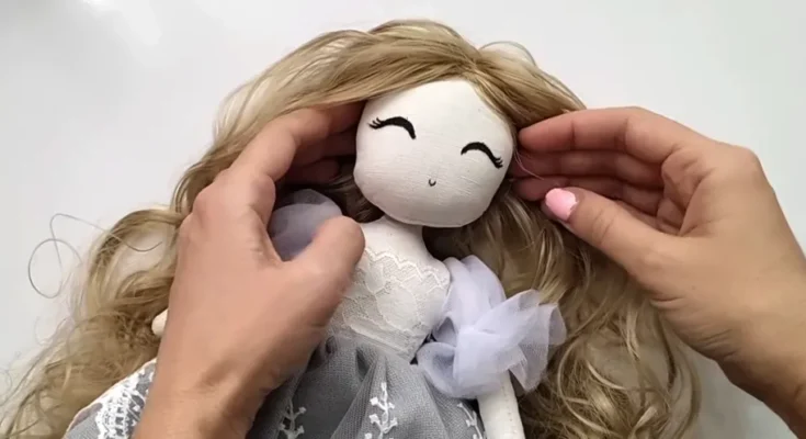 A person's hands and a doll | Source: YouTube/CraftyGirlShirin