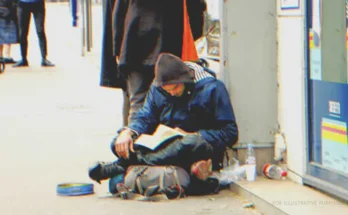 A homeless man reading a book | Source: Shutterstock