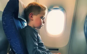 A sad and nervous little boy sitting in his seat on a plane | Source: Amomama