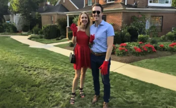 A couple wearing red gloves standing outside a house | Source: AmoMama