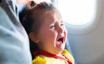 A little girl crying in an airplane | Source: Shutterstock