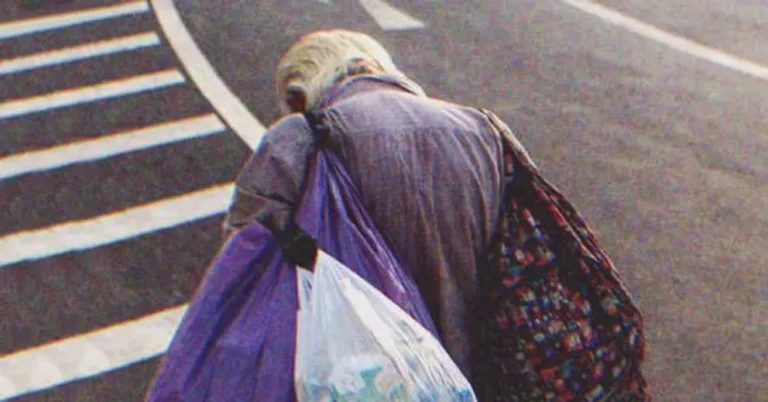 An old poor man walking down the street | Source: Shutterstock