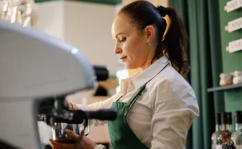 A female barista making coffee | Source: Shutterstock