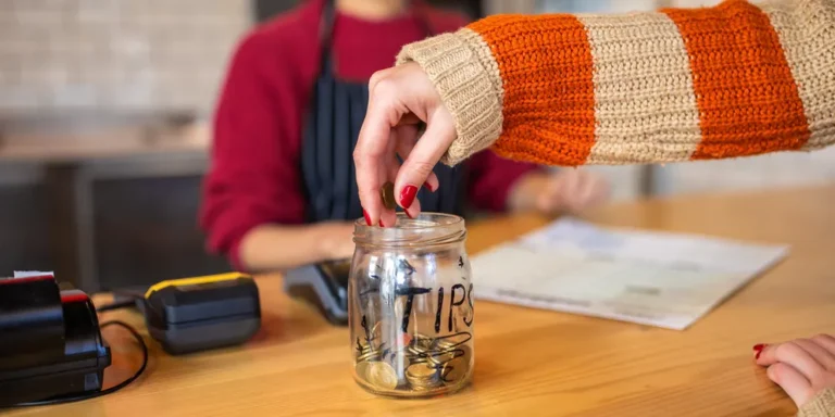 A female customer leaving tips at the tip jar | Source: Getty Images