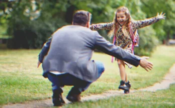 A happy little girl running towards a man | Source: Shutterstock