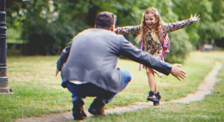 A happy little girl running towards a man | Source: Shutterstock