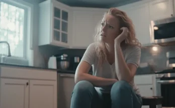 Frustrated woman sitting at the kitchen | Source: Midjourney