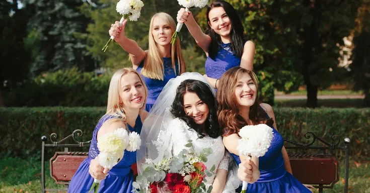 A happy bride surrounded by her bridesmaids | Source: Freepik