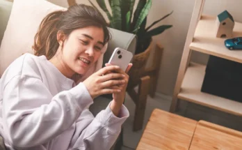 A woman using her phone | Source: Shutterstock