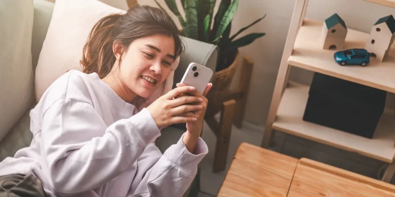 A woman using her phone | Source: Shutterstock