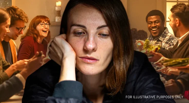 A woman looking sad while people laugh in the background | Source: Shutterstock