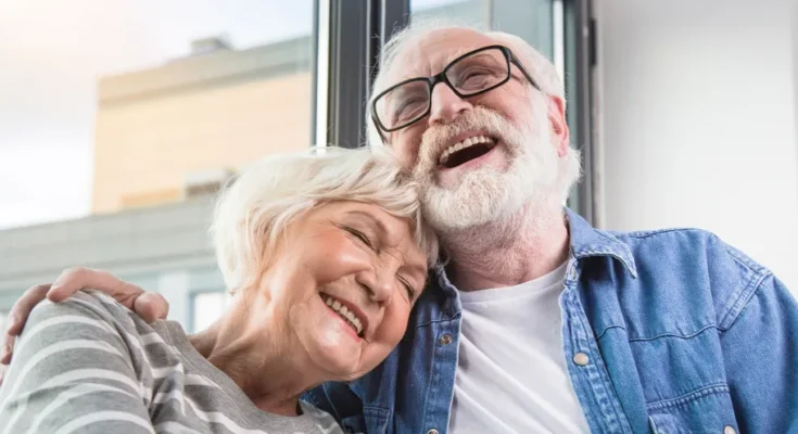 A mature couple laughing together | Source: Shutterstock