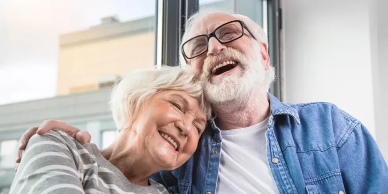 A mature couple laughing together | Source: Shutterstock