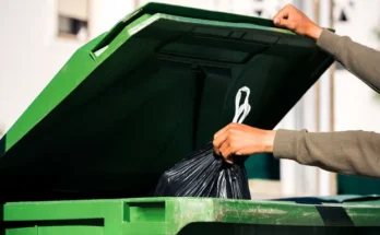 A person throwing trash into a bin | Source: Shutterstock