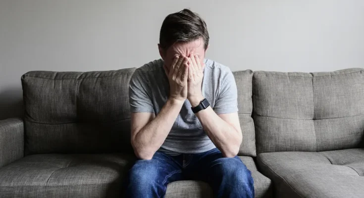 Upset man sitting on a couch | Source: Getty images