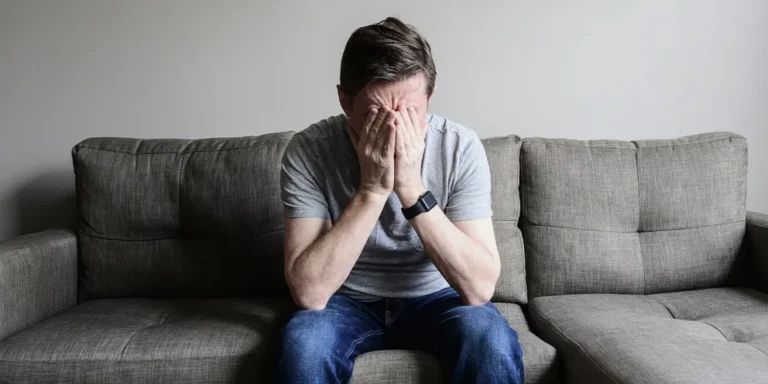 Upset man sitting on a couch | Source: Getty images