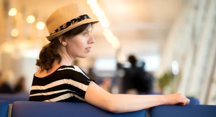 A woman sitting at the airport | Source: Shutterstock