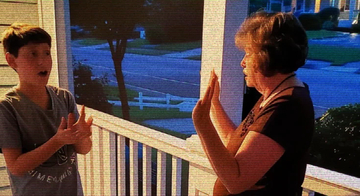 A woman and a boy talking on a porch | Source: AmoMama