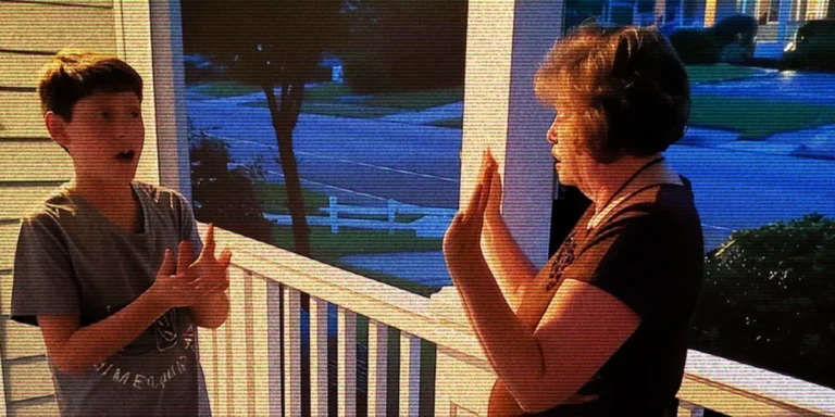 A woman and a boy talking on a porch | Source: AmoMama