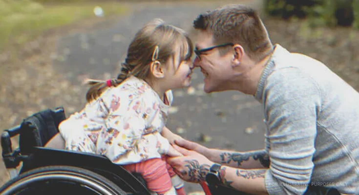 Man leaning nose to nose with disabled girl. | Source: Getty Images