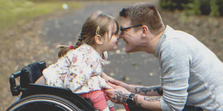 Man leaning nose to nose with disabled girl. | Source: Getty Images