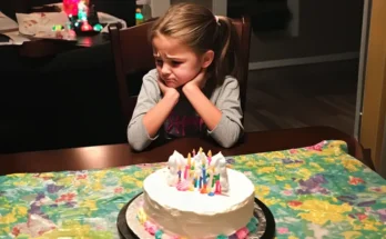 An upset girl in front of her cake | Source: Amomama