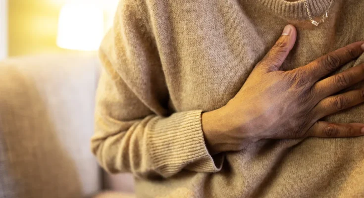 A person with a hand on their chest | Getty Images